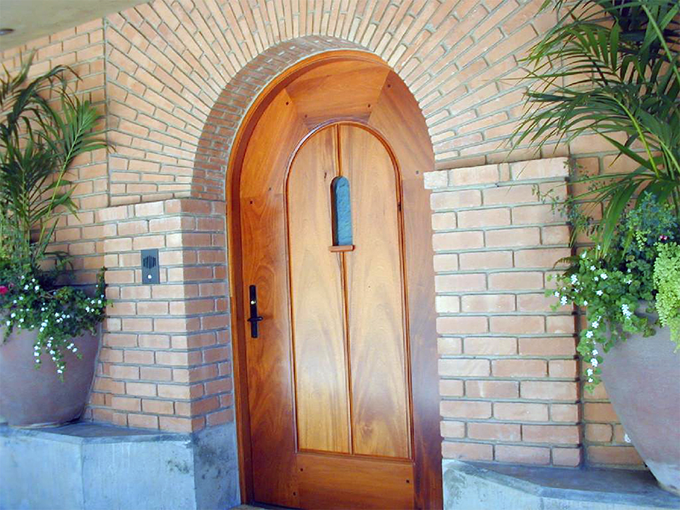 Hand laid brick entry arch with wood door