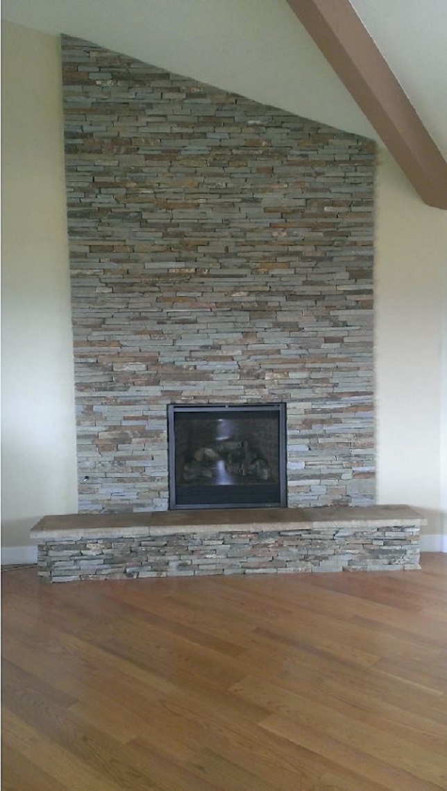 Floor to ceiling stacked stone fireplace