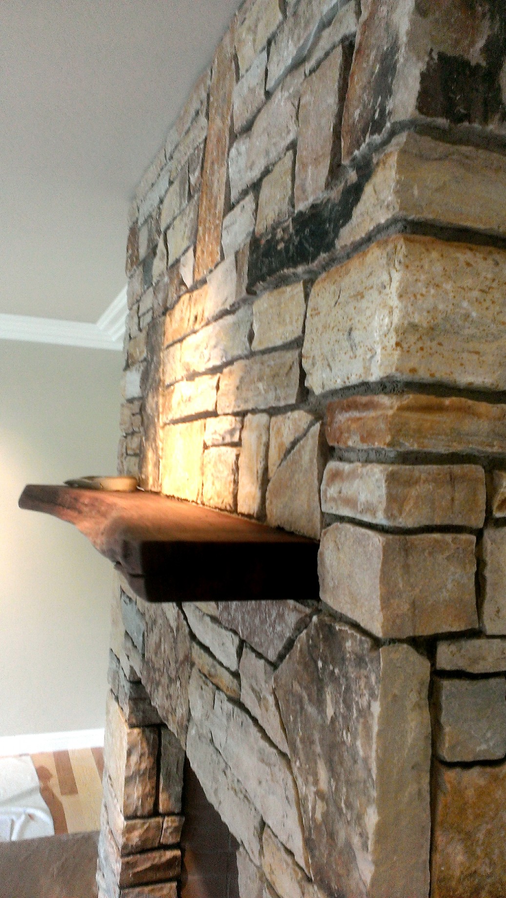 Dry stacked stone fireplace with live edge wood mantel